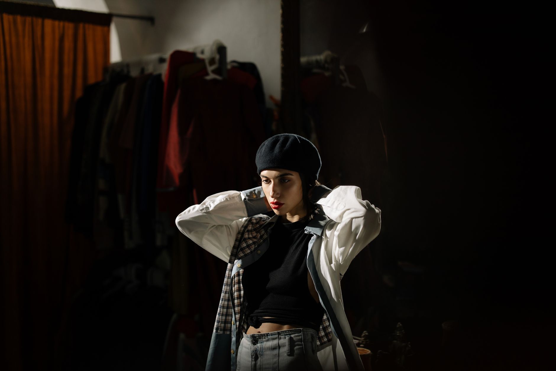 Stylist in a moody boutique wardrobe